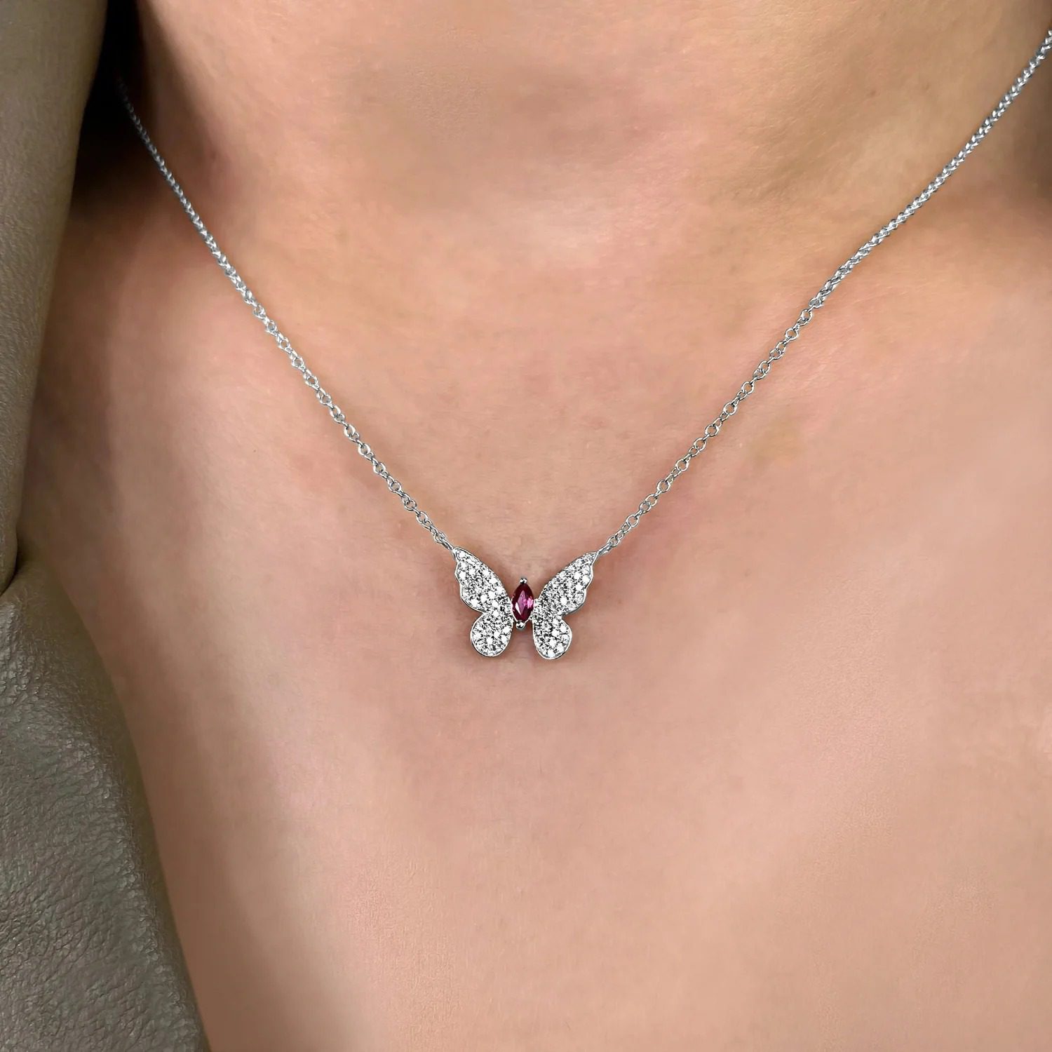 Silver butterfly necklace set with a marquise-cut red stone (3.05.g)